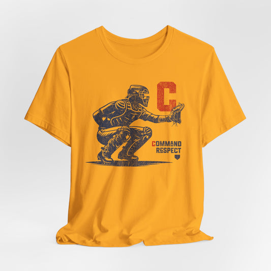 Gold t-shirt featuring a baseball catcher and the words COMMAND RESPECT in navy, and a red letter C.
