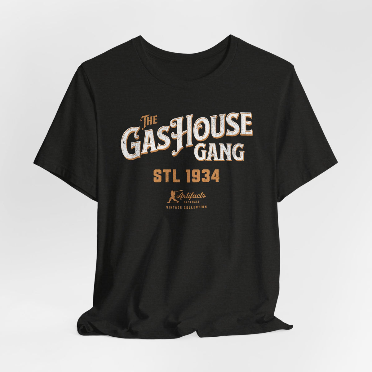 A black short-sleeve t-shirt with a vintage-style graphic print reading 'The Gas House Gang STL 1934' and a small 'Artifacts Collection' logo.