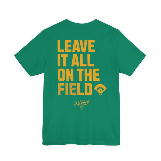 A green t-shirt back with the phrase LEAVE IT ALL ON THE FIELD printed in bold gold letters, with a baseball field graphic.