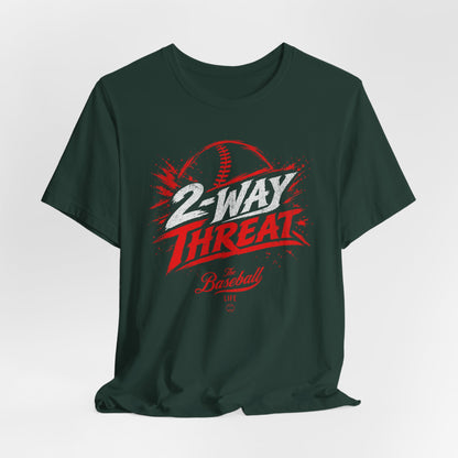 A forest green baseball t-shirt featuring a high-energy "2-WAY THREAT" graphic with The Baseball Life logo.