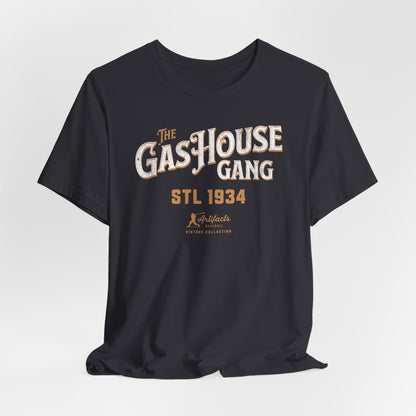 A dark grey short-sleeve t-shirt with a vintage-style graphic print reading 'The Gas House Gang STL 1934' and a small 'Artifacts Collection' logo.
