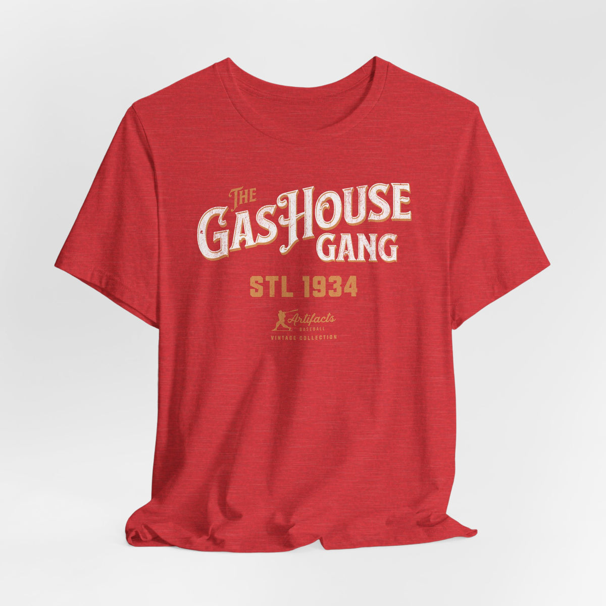 A heather red short-sleeve t-shirt with a vintage-style graphic print reading 'The Gas House Gang STL 1934' and a small 'Artifacts Collection' logo.
