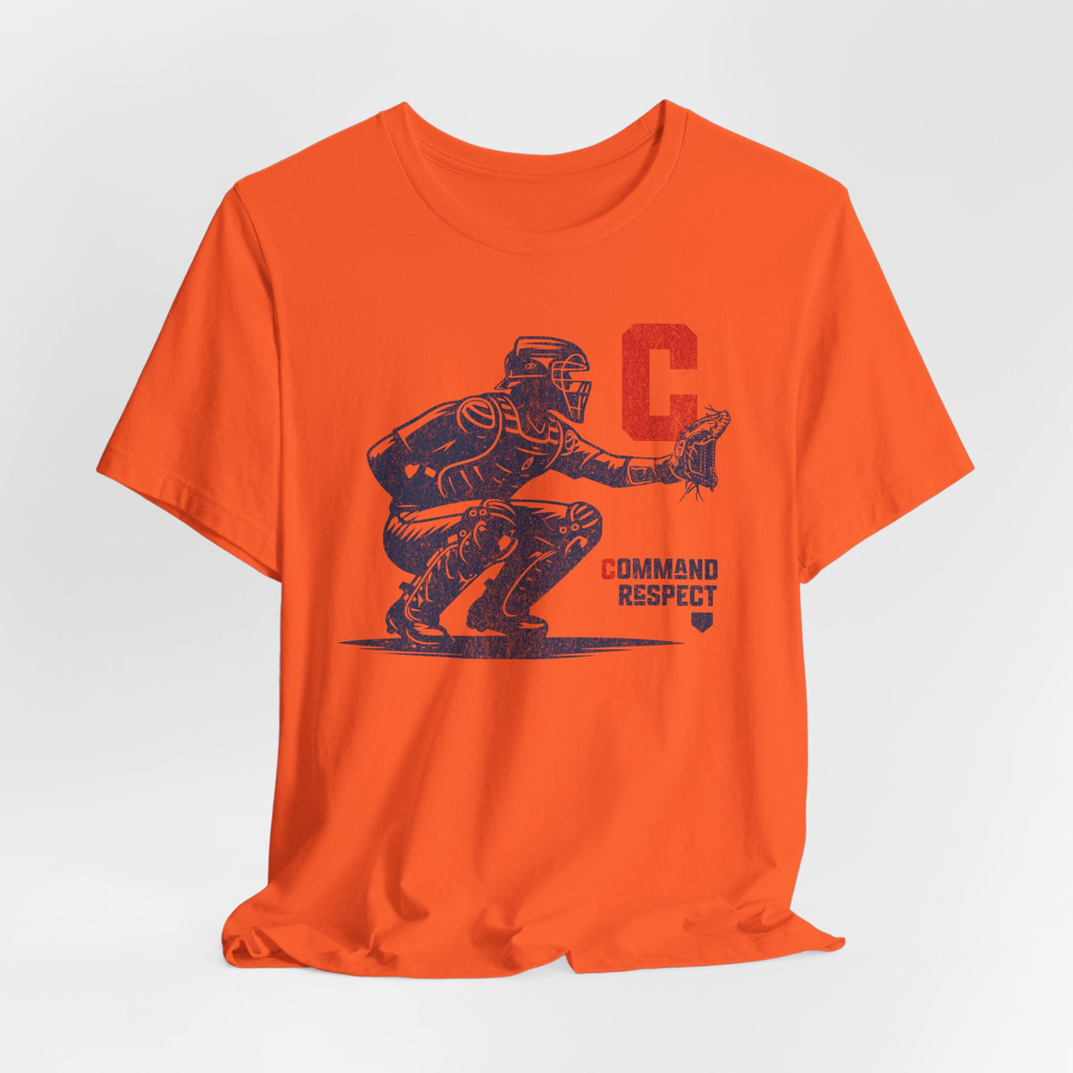 An orange t-shirt featuring a baseball catcher and the words COMMAND RESPECT in navy, and a red letter C.