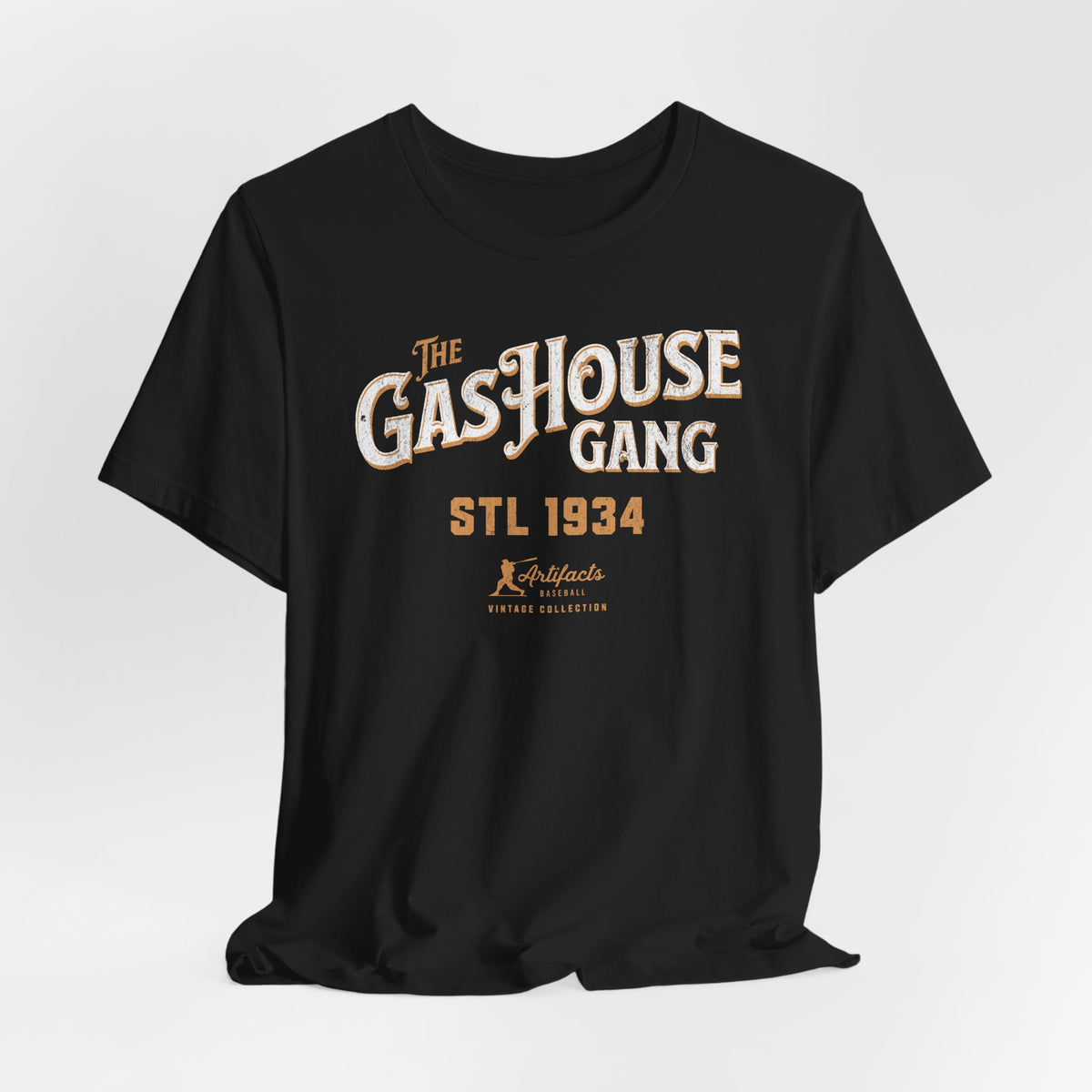 A black short-sleeve t-shirt with a vintage-style graphic print reading 'The Gas House Gang STL 1934' and a small 'Artifacts Collection' logo.