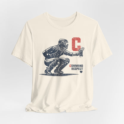 A natural (off-white) t-shirt featuring a baseball catcher and the words COMMAND RESPECT in navy, and a red letter C.
