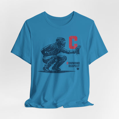 An aqua t-shirt featuring a baseball catcher and the words COMMAND RESPECT in navy, and a red letter C.
