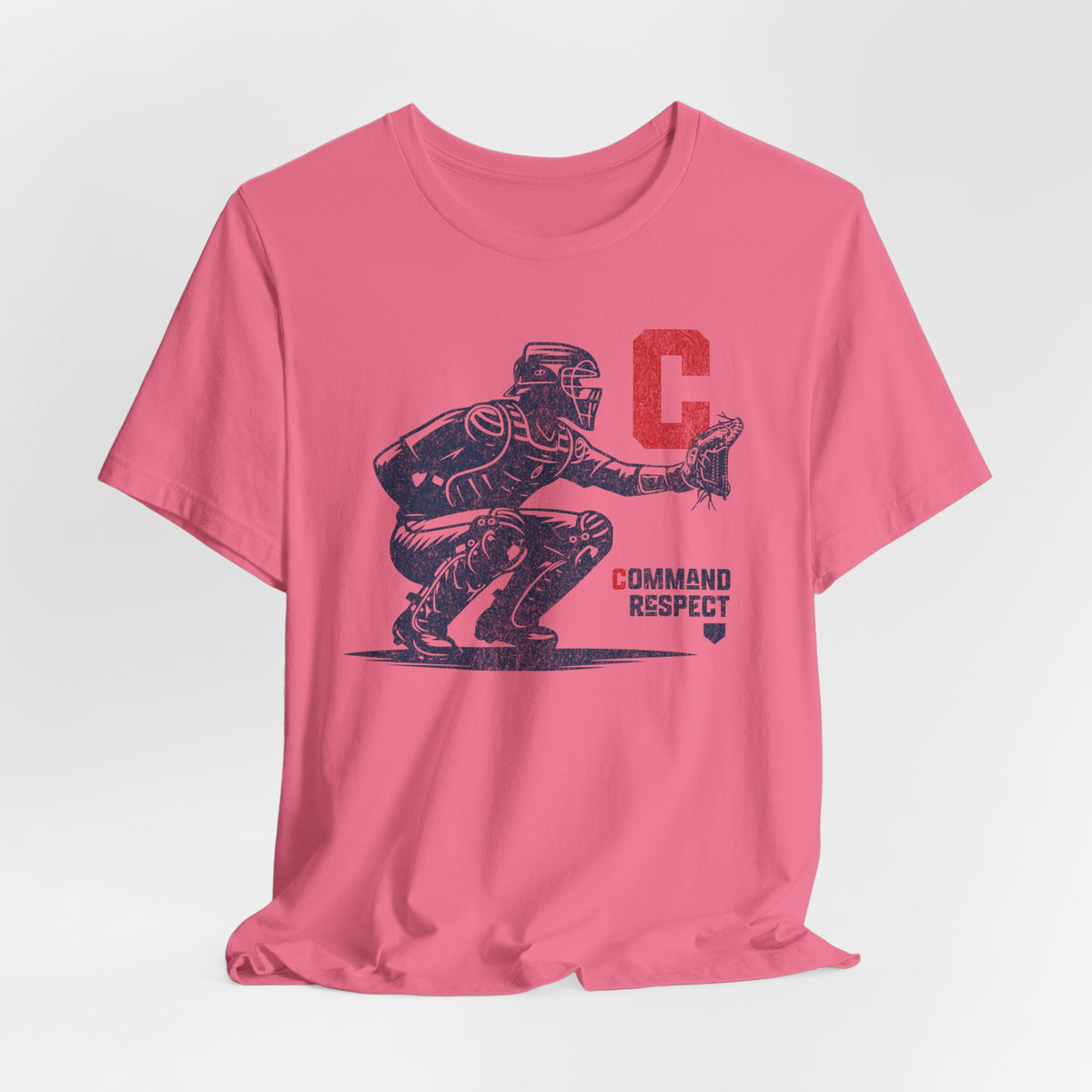 A charity pink t-shirt featuring a baseball catcher and the words COMMAND RESPECT in navy, and a red letter C.