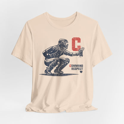 A soft cream t-shirt featuring a baseball catcher and the words COMMAND RESPECT in navy, and a red letter C.