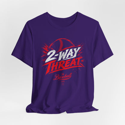 A purple baseball t-shirt featuring a high-energy "2-WAY THREAT" graphic with The Baseball Life logo.