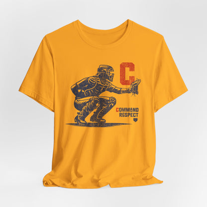 Gold t-shirt featuring a baseball catcher and the words COMMAND RESPECT in navy, and a red letter C.