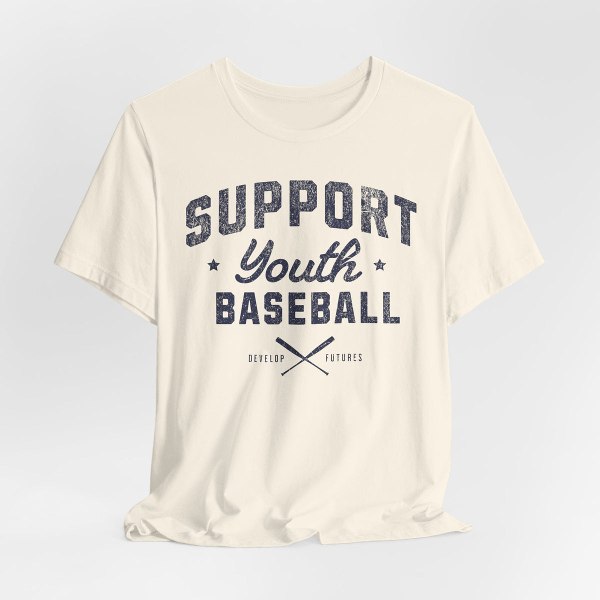 An off white t-shirt with a distressed navy blue graphic on the front that reads SUPPORT YOUTH BASEBALL with crossed bats.