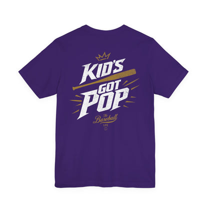 The back of a purple baseball t-shirt with the slogan Kid's Got Pop and a baseball bat graphic.