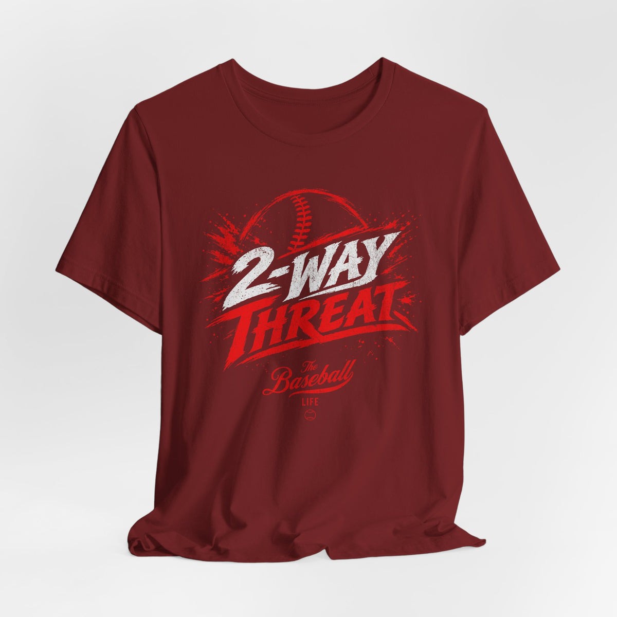 A cardinal red baseball t-shirt featuring a high-energy "2-WAY THREAT" graphic with The Baseball Life logo.