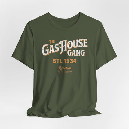 A military green short-sleeve t-shirt with a vintage-style graphic print reading 'The Gas House Gang STL 1934' and a small 'Artifacts Collection' logo.