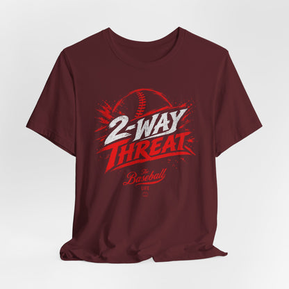A maroon baseball t-shirt featuring a high-energy "2-WAY THREAT" graphic with The Baseball Life logo.