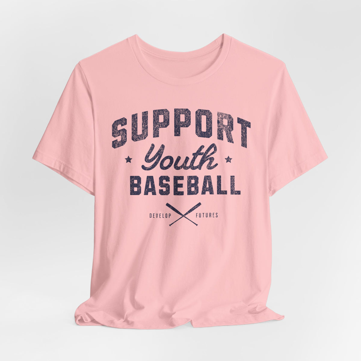 A light pink t-shirt with a distressed navy blue graphic on the front that reads SUPPORT YOUTH BASEBALL with crossed bats.